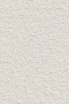 a white stucco wall textured with light gray paint