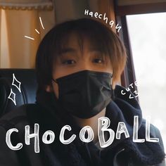 a person wearing a black face mask with the words chocoball written on it