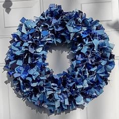 a blue wreath hanging on the side of a door