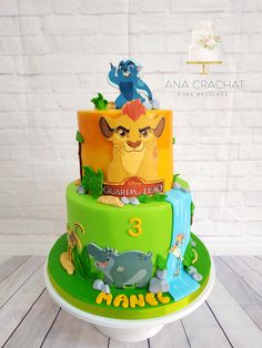 the lion king birthday cake is decorated with fondant and edible images from disney's live - action films