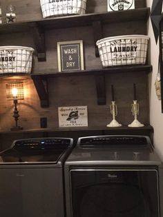 a washer and dryer in a laundry room with baskets on the shelves above