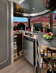 a kitchen area with an oven, dishwasher and sink in the middle of it