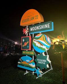 there is a sign that says moon shine at the end of this night time event