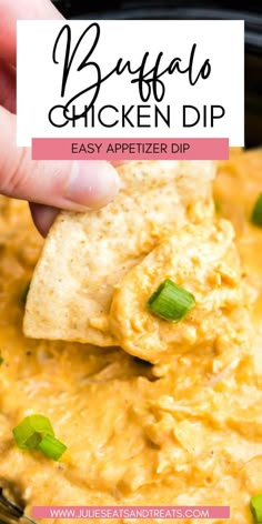 a hand holding a tortilla chip over a bowl filled with chicken dip and garnished with cilantro