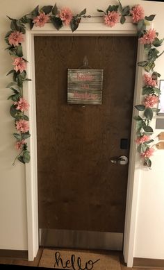 the door is decorated with pink flowers and leaves