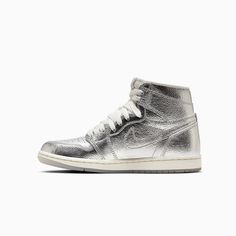 Air Jordan 1 Retro HighWomen's ShoesEvery Jordan Retro is a classic sneaker done up in new colors and textured for a fresh look. Shiny metallic cracked leather and a tinted translucent outsole help this iteration bring all your chrome dreams to life. Premium materials and accents keep the look modern and on point.Leather offers durability and structure.Encapsulated Air unit provides lightweight cushioning.Rubber outsole helps give you traction on various surfaces. Color: Silver Photon Dust Sail