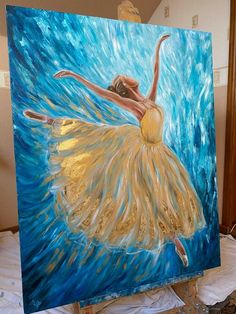 a painting of a ballerina in yellow and blue is being displayed on a easel