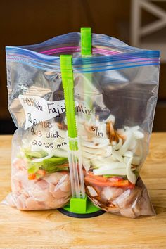 two bags of food sitting on top of a wooden table