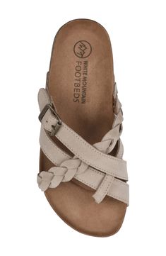 Traditional buckle slide Harrington leather sandal by White Mountain Footbeds(TM) with braided straps over the top of the foot is a new addition to your easy summer style. Featuring our signature molded suedette footbed with comfort heel cup, this sandal is a great everyday summer style.Sizing: True to size. M=standard width . Toe loop. Leather upper. Buckled strap detail. Slip-on. Contoured footbed. Mule back. Imported  This item cannot be shipped to Canada. Leather upper, synthetic sole Casual Beige Braided Sandals, Casual Adjustable Toe Loop Slides, Beige Suede Sandals With Woven Sole, Casual Braided Leather Sandals, Comfortable Braided Sandals, Adjustable Beige Sandals With Braided Straps, Comfortable Slip-on Sandals With Braided Straps, Adjustable Leather Slides With Flat Heel, Comfortable Open Toe Slides With Braided Straps