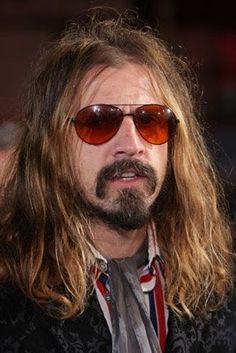 a man with long hair and sunglasses on