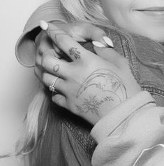 black and white photograph of a woman with tattoos on her arm