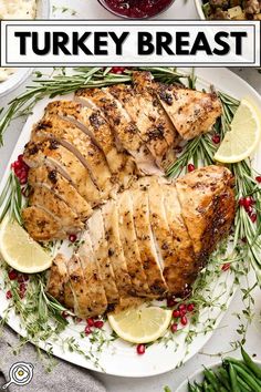 turkey breast on a plate with lemons and cranberry sauce