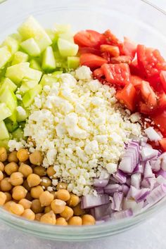 chopped vegetables and chickpeas in a glass bowl