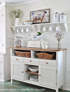 a kitchen with white cabinets and baskets on the shelves