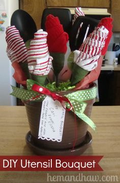 an arrangement of kitchen utensils in a pot on a table with the words diy utensil bouquet