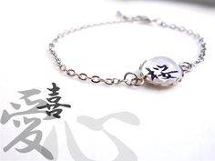 Japanese Bracelet with a Kanji of your choice in silver color - Black text on White background - Tray dia approx. 1/2 in / 12.7mm Extender chain 2 in / 5cm non-water resistant select [ 1 ] Select a Kanji from 24. [ 2 ] Size (your wrist size) Other size? Ask me before purchasing. * Non-water resistant. Tracking number The shipping cost does not include a tracking number. Add this if you need : www.etsy.com/listing/177273933 Please read Shop Policies before purchasing. ありがとう (Arigatoh/ Thanks) for Customizable Silver Charm Bracelet, Customizable Silver Name Bracelet, Customizable Silver Round Name Bracelet, Customized Minimalist Silver Bracelets, White Engraved Round Bracelets, Customized Silver Name Bracelet, White Chain Bracelet With Adjustable Chain, White Round Chain Bracelet With Adjustable Chain, White Chain Bracelet With Adjustable Chain As A Gift