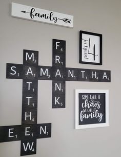 a cross is mounted on the wall with family names