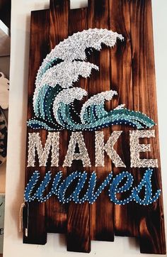 a wooden sign that says make waves on the front and back with beaded words