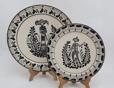 two black and white plates on wooden stands