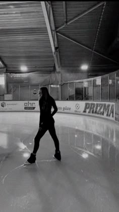 a man standing on top of an ice rink holding his hands on his hips as he skates