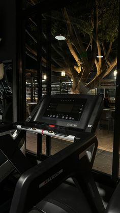 there is a treadmill in front of a window with a view of the street