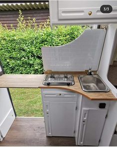 a small kitchen with an oven and sink