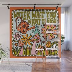 an orange wall mural with flowers and watering can in the center that says water what you want to ski