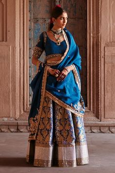 Peacock blue flared katan silk brocade banarasi kali lehenga with all over mughal bloom pattern and hand embroidered border. Paired with a half sleeves jewel neck padded blouse with intricate zardozi vine embroidery on the neckline, sleeves and blossom zardozi embroidered organza dupatta with kiran lace border embellishments. - Aza Fashions Cape Lehenga, Brocade Lehenga, Kurta Lehenga, Indian Blue, Lehenga Skirt, Lehenga Blouse, Katan Silk