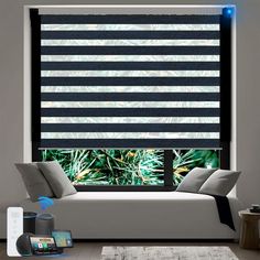 a living room with black and white striped blinds on the window sill, phone charging in front of it