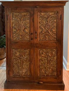 an old wooden armoire with carvings on it