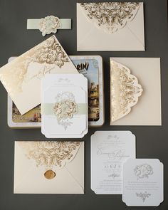 the wedding stationery is laid out on top of each other, including envelopes and cards