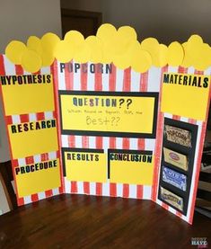 a table with some signs on it that say, pop corn questions and what is the best one?