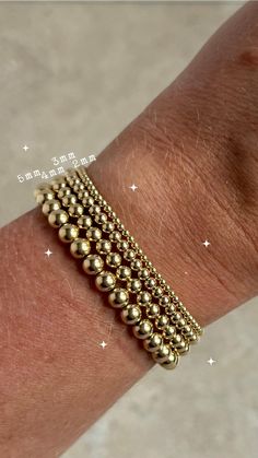 E S S E N T I A L ∙ B E A D ∙ B RA C E L E T S Gold Filled Classic Stretch Bead Bracelet. Simple but elegant. You won't want to take these off -- and you won't have to! Available in various bead sizes. 2mm, 3mm, 4mm, 5mm, 6mm. * Material: High Quality 14Kt Gold Filled  * Tarnish Proof and made to last H O W ∙ T O ∙ O R D E R  * Select your bracelet size in the drop down menus. * Select the desired bead size  O T H E R ∙ I N F O R M A T I O N SIZING: Use a tape measure, wrap the tape measure arou Gold Ball Bracelet, Gold Bead Bracelet, Bead Sizes, Bracelet Simple, Ball Bracelet, Gold Bead Bracelets, Bead Bracelets, Beaded Stretch Bracelet, Gold Filled Jewelry