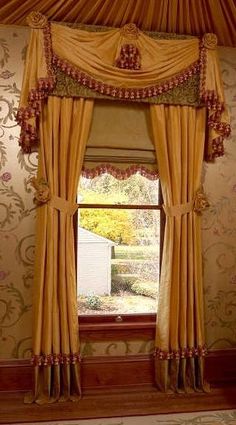 a window with curtains hanging from it's sides