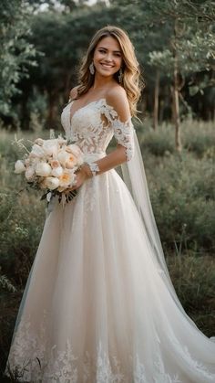 a woman in a wedding dress posing for the camera with her bouquet and veil over her shoulder