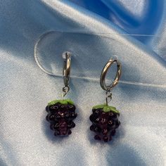 These earrings are perfect for berry lovers! The Glass Blackberry Hoop Earrings are delicately crafted using glass beads, and are also available in red as Raspberries. Height: 1.5cm, Width: 1cm Material: Glass Care instructions: For best results, please keep these away from water, perfume and other chemicals. Store in a cool, dry place. Disclaimer: Our earring hooks are typically friendly on the skin, however they may not be suitable for hyper-sensitive and hyper-allergic skin. This includes our stainless steel and sterling silver earrings. Blackberry Earrings, Water Perfume, Gift Bundles, Gold Colour, Earring Sale, Earring Hooks, Blackberry, Clip On Earrings, Sake