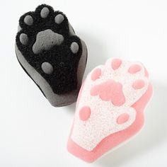 two sponges with paw prints on them, one is pink and the other is black