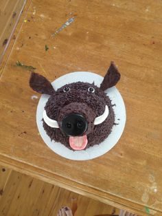 a cake shaped like a boar's head on top of a wooden table