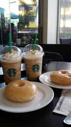 two donuts and three cups of coffee on a table