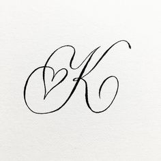 the letter k is written in cursive writing with black ink on white paper