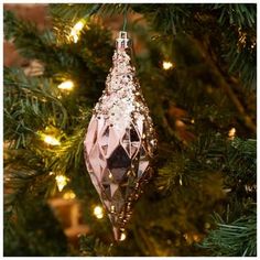 a pink ornament hanging from a christmas tree