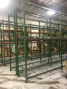 an industrial warehouse with lots of metal shelving