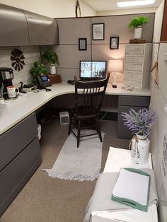 an office cubicle with desk, chair and computer