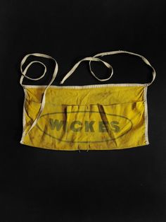 an old yellow bag with the words woks on it's front and side