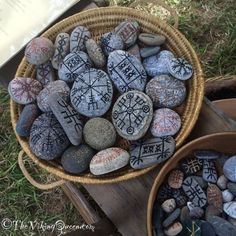 two baskets filled with rocks sitting on top of a grass covered ground next to each other