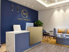 the front desk of a medical office with blue walls and wood flooring is shown