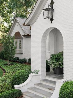 the instagram page shows an image of a white house with landscaping and trees in front