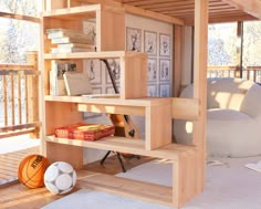 there is a loft bed with stairs and bookshelves in the room that has a basketball on the floor next to it