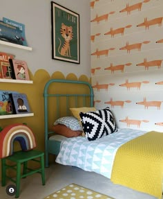 a bed room with a neatly made bed and colorful wallpaper