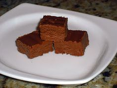 four pieces of brownie on a white plate